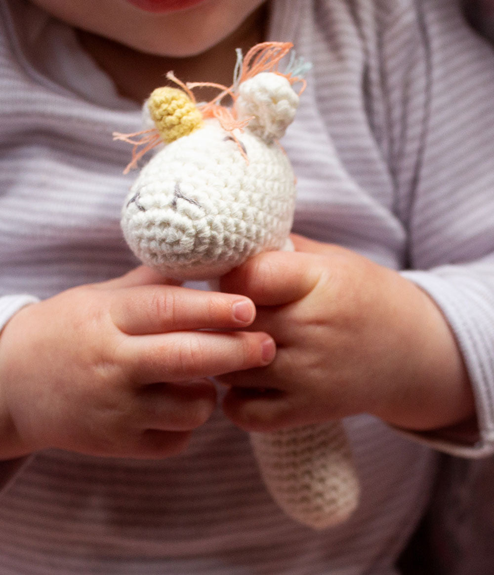 Baby holding Crochet Rattle Twinkle Twinkle