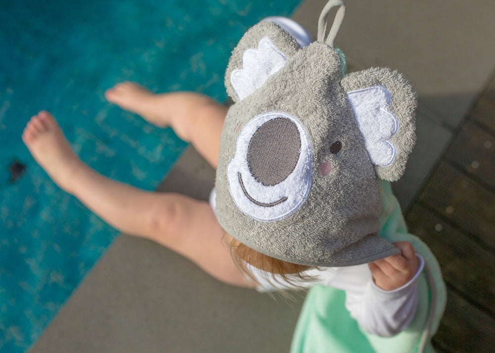 Baby on the poolside enjoying with Mint Koala Hooded Towel