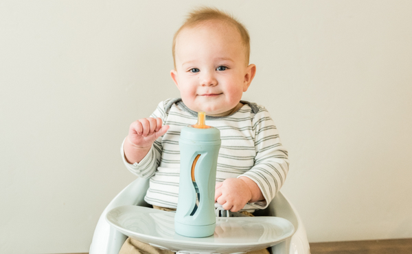 baby with food bottle