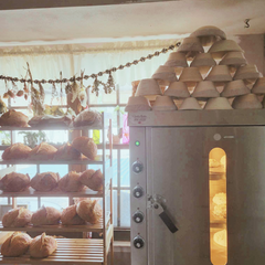 Simply Silva's Rackmaster in her cottage bakery with sourdough bread on shelves