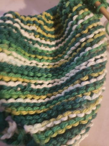 Green variant dishcloth on knitting needles 