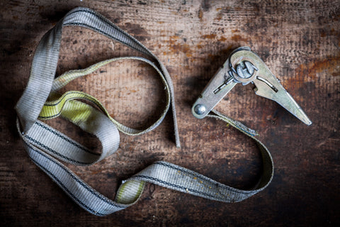 A set of old, rusted and frayed ratchet straps. This single picture tells a relatable story of what a typical ratchet strap looks like, why ratchet straps always get stuck, and why it is time for a better ratchet strap.