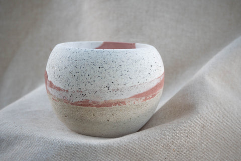 Bowl shaped plant pot with red, cream and white layered colours