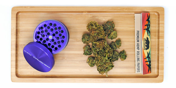 Grinder, product, and rolling papers on tray