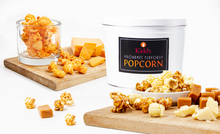 Load image into Gallery viewer, assorted flavors of caramel, cheese and white cheddar gourmet popcorn displayed with a white 2 gallon gift tin.
