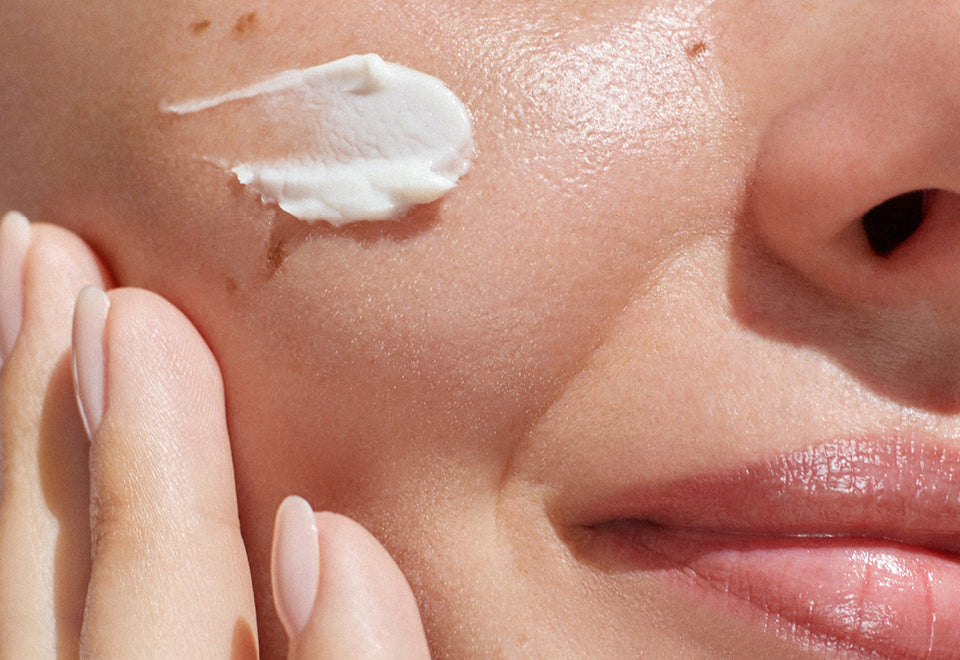 Close Up Of Womans Check With Skincare Product