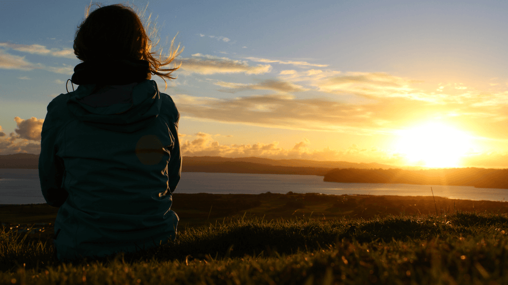 woman-sitting-watching-sunset