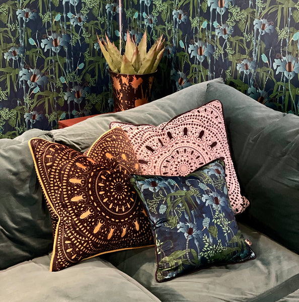 Sofa with array of patterned cushions from The Curious Department