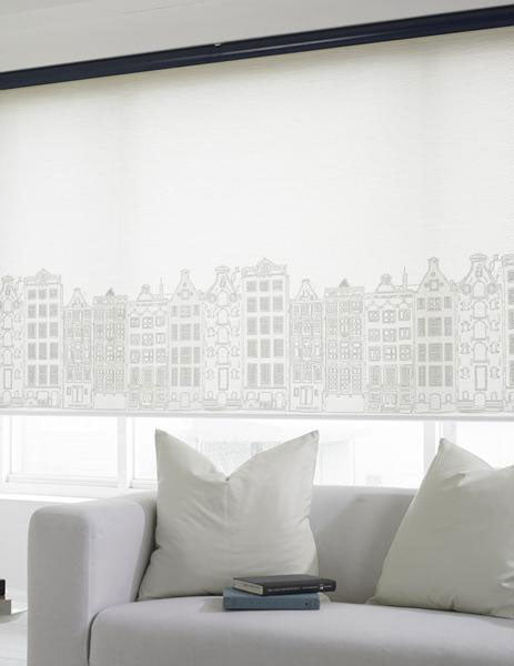 Elite shades custom printed with a hand-drawn cityscape across the bottom and installed on a living room window