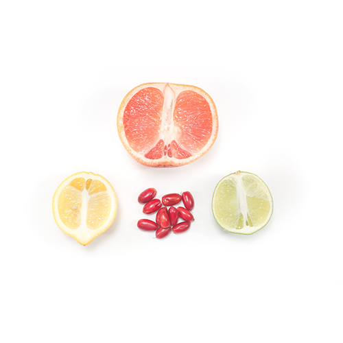 miracle berries with a lemon, lime, and grapefruit. Arranged in a triangle with miracle fruit in the middle