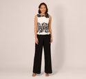 Sleeveless Peplum Jumpsuit With Scroll Lace Details In Ivory Black