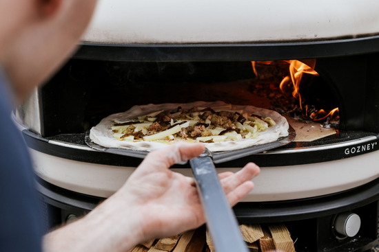 Pizza cooking in Gozney Dome pizza oven