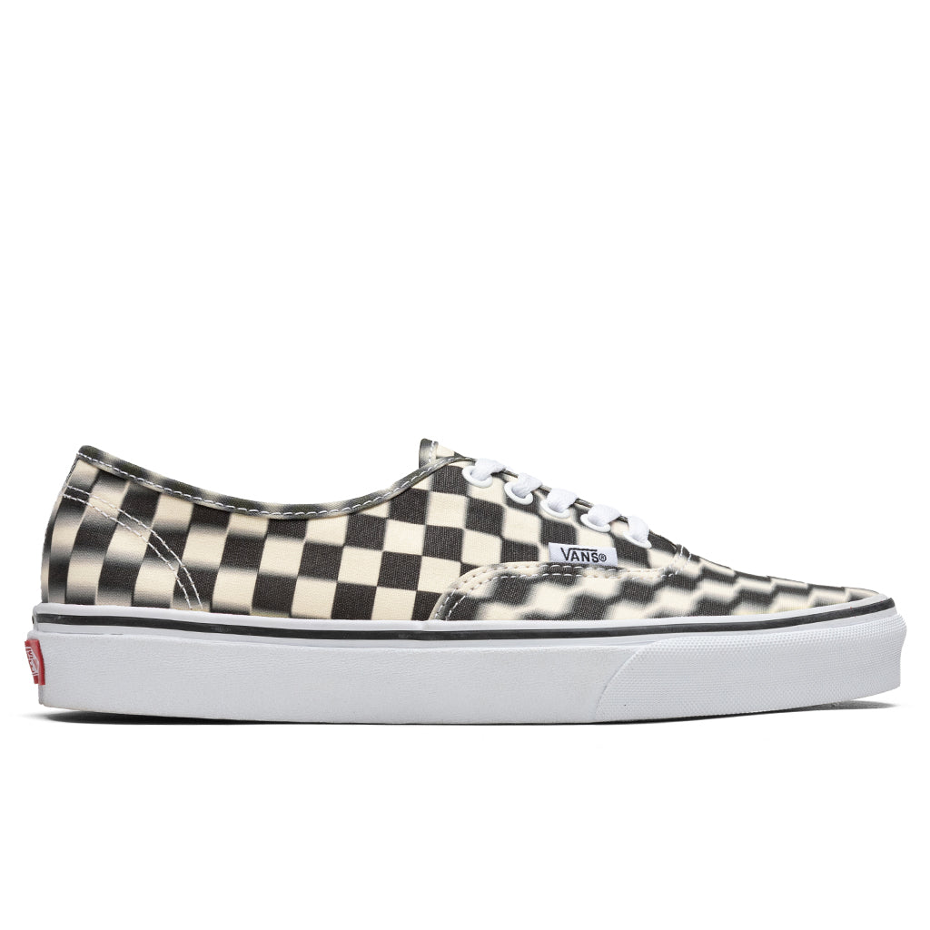 blurred checkerboard vans slip on