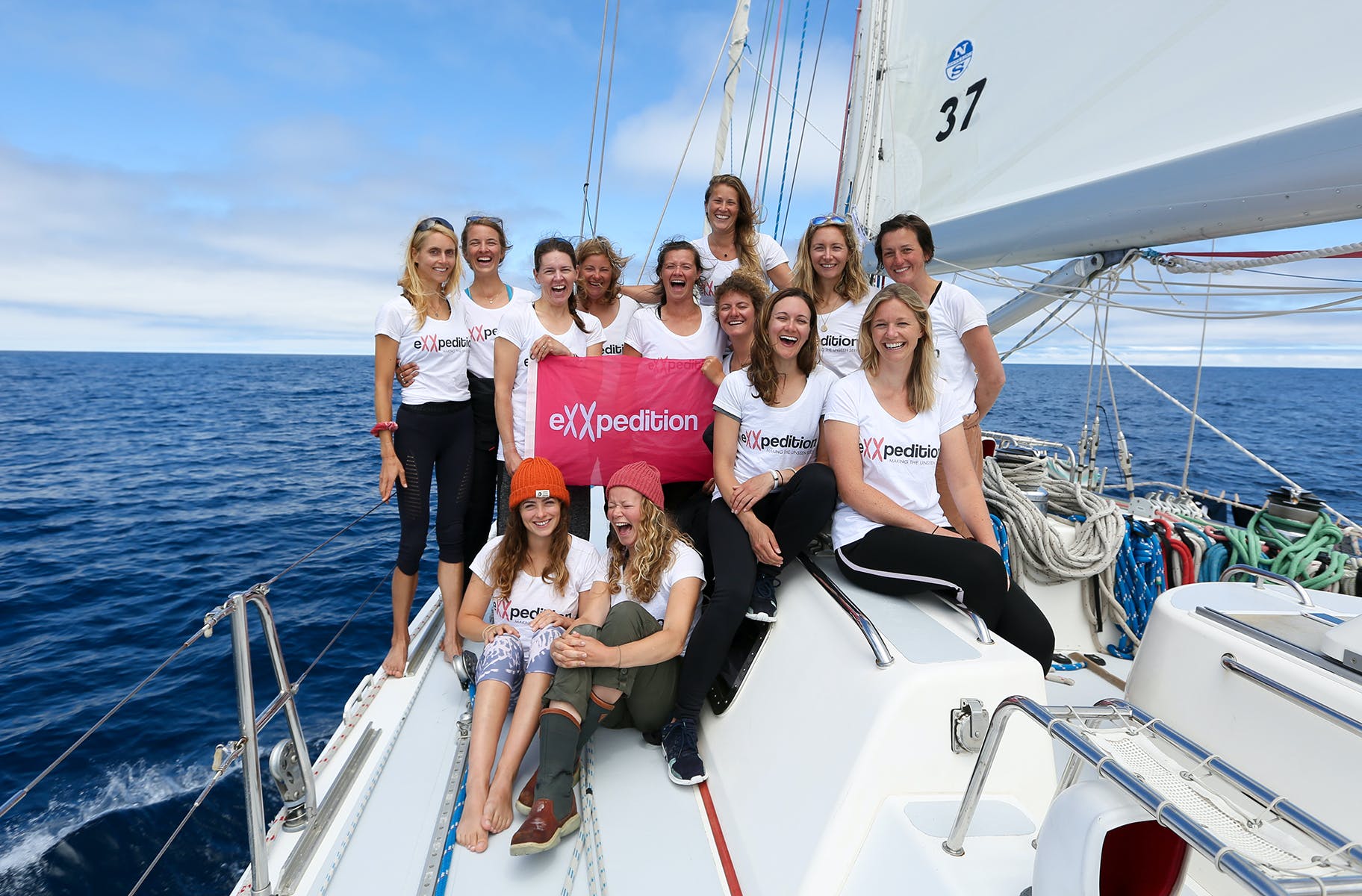 The women of eXXpedition, pictured on their boat in the ocean. 