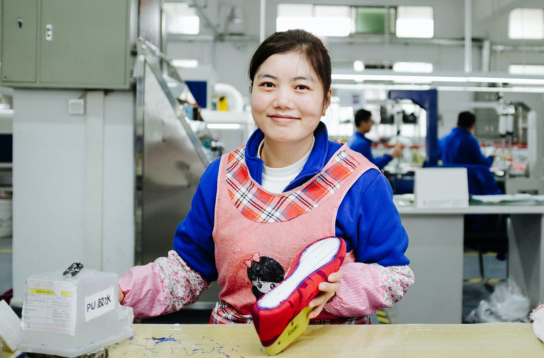 A team member shown constructing our shoes by hand. 