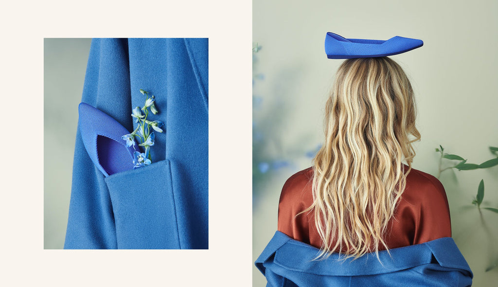 On the left, The Point in Cornflower shown in a pocket of a blue coat. On the right, The Point in Cornflower shown balanced on top of a model's head. 