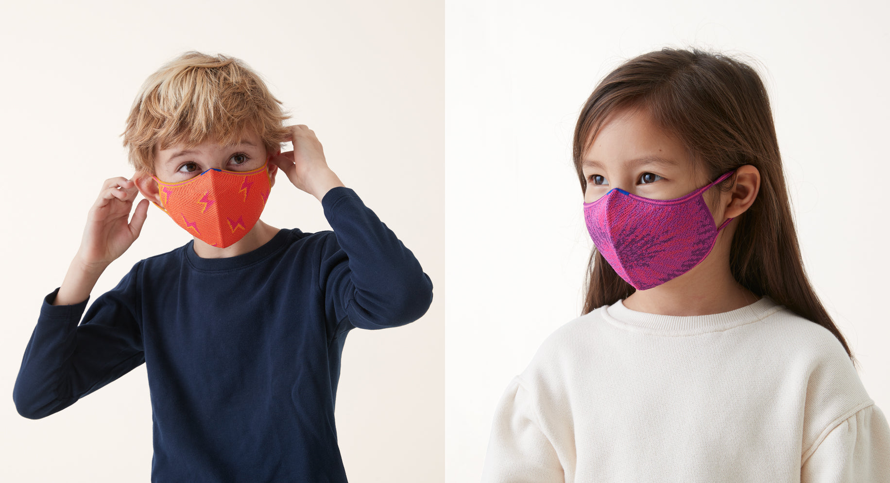 Boy in a navy sweater wearing a bright orange kids mask with a hot pink lightning bold pattern