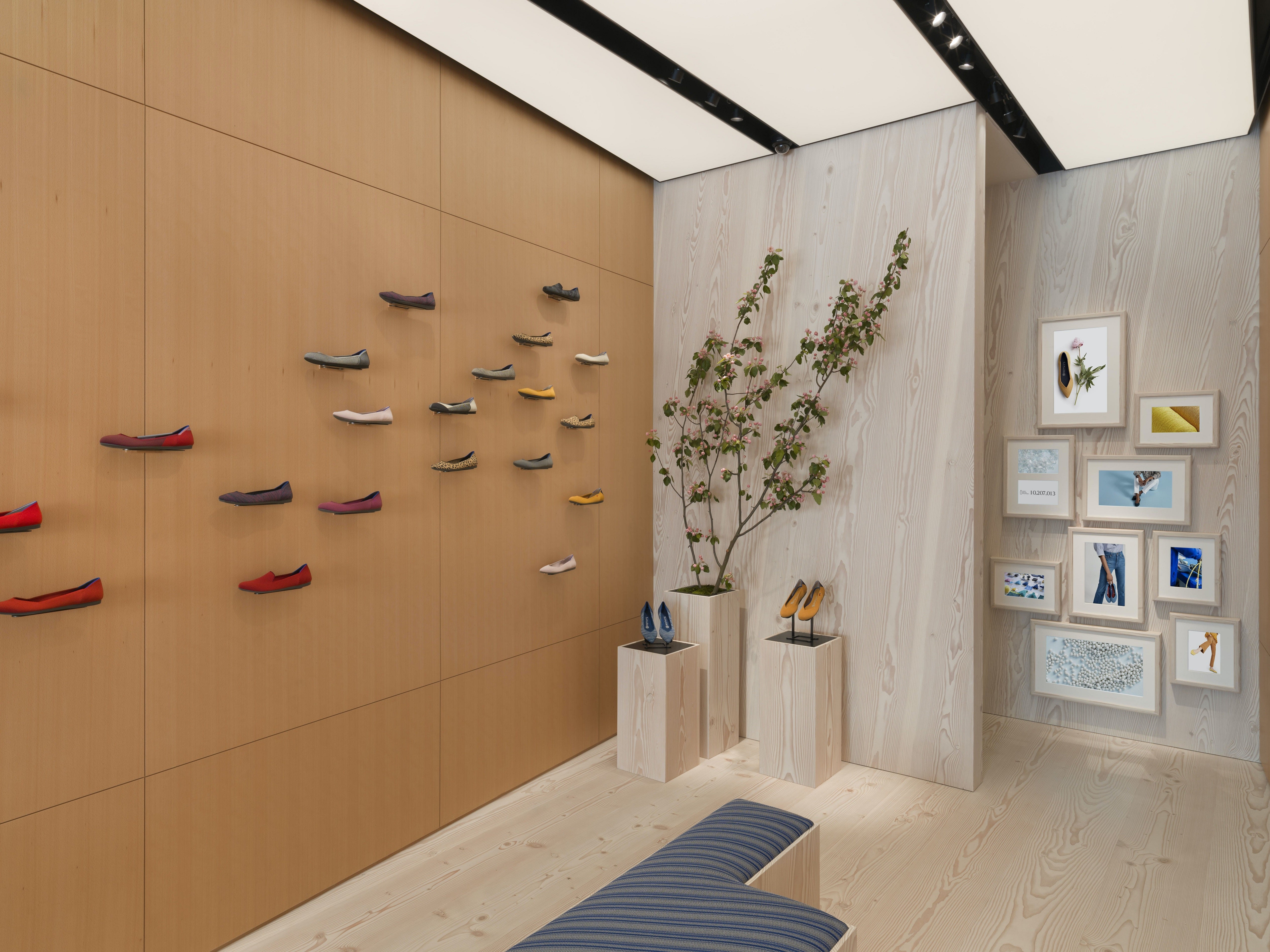 The interior of our Fillmore store, with shoes perched on a wood-paneled wall. 