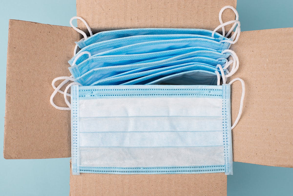 A box of disposable masks, shown from the top. 