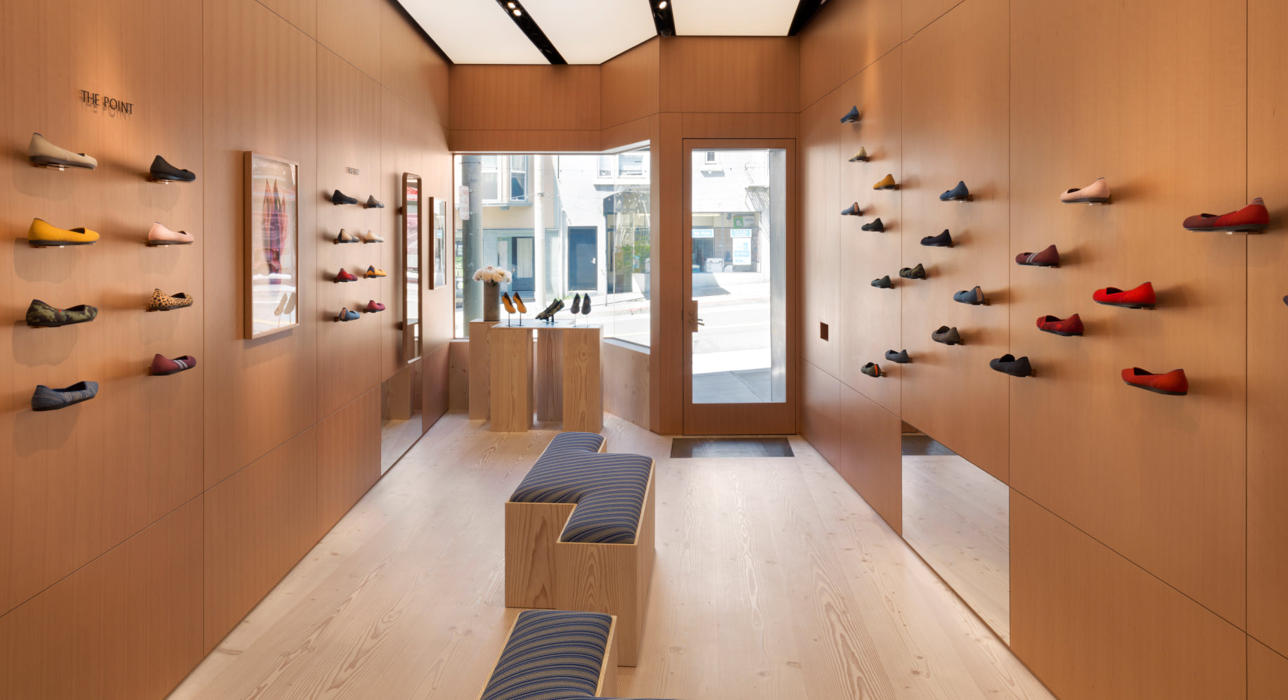 Interior view of our San Francisco retail store, with shoes displayed on the wall. 