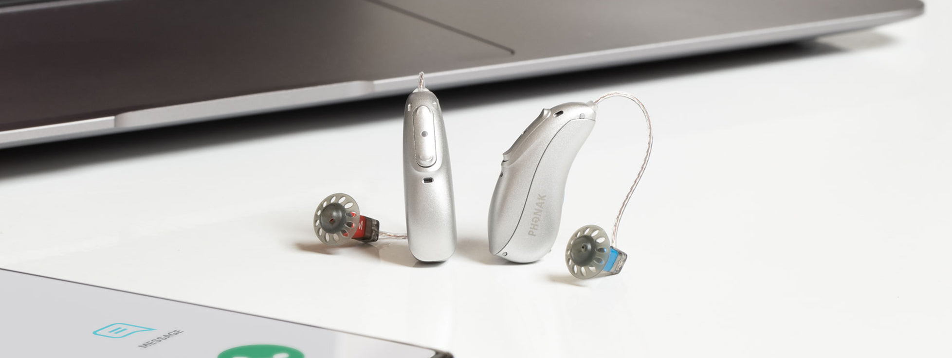 A pair of rechargeable Phonak Lumity L90 hearing aids.