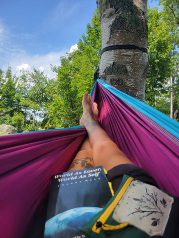 Rachael Amber on a hammock reading a book