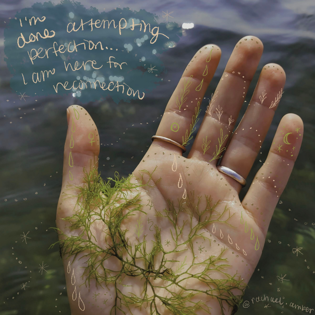Hand with a quote written on top holding moss