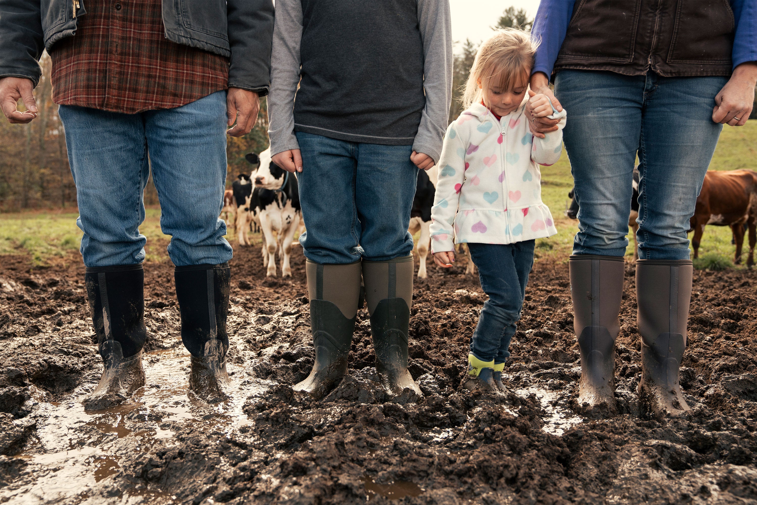 Family wearing Muck Boots standing in mud