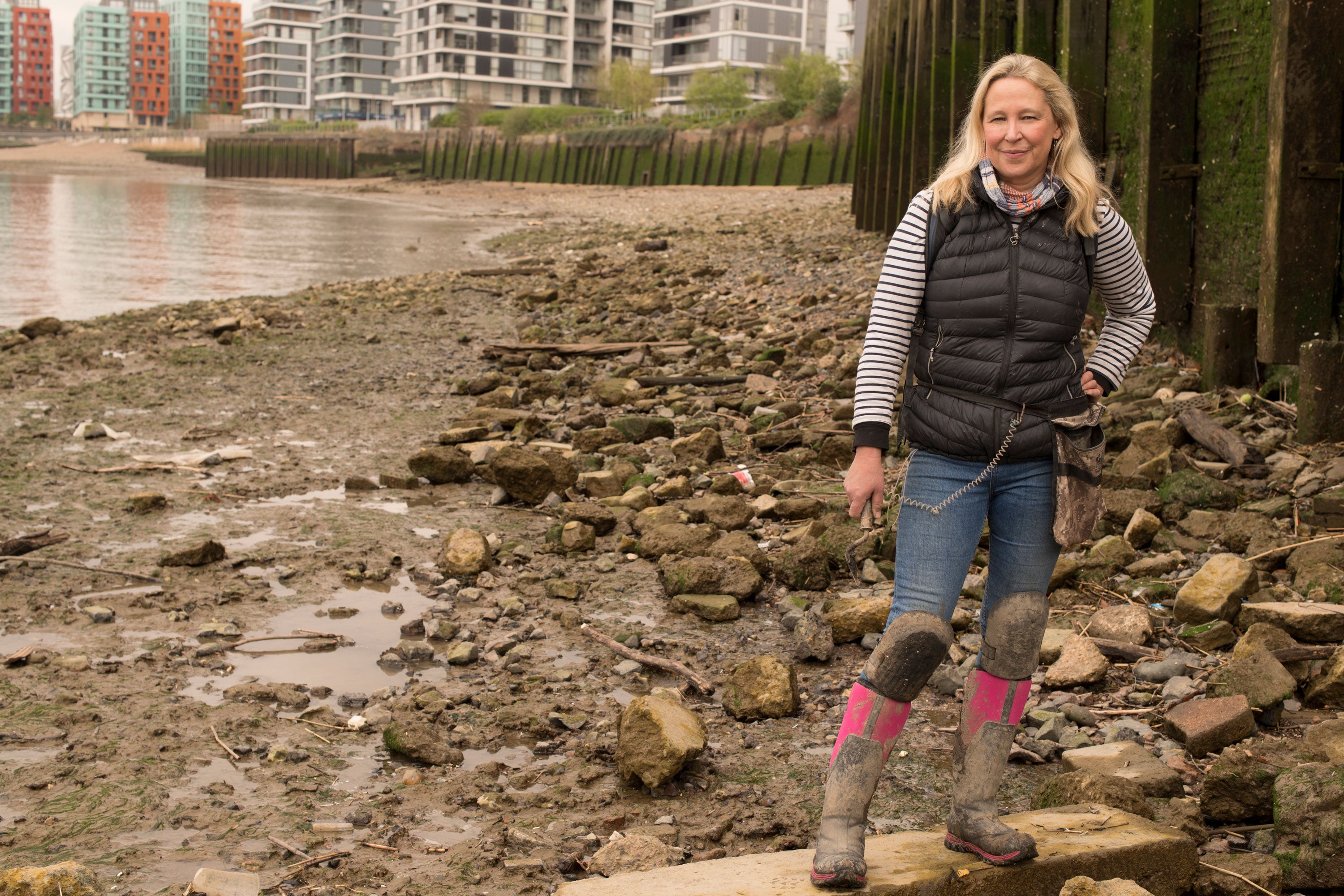 Nicola stood on rocks with the flood barrier behind her