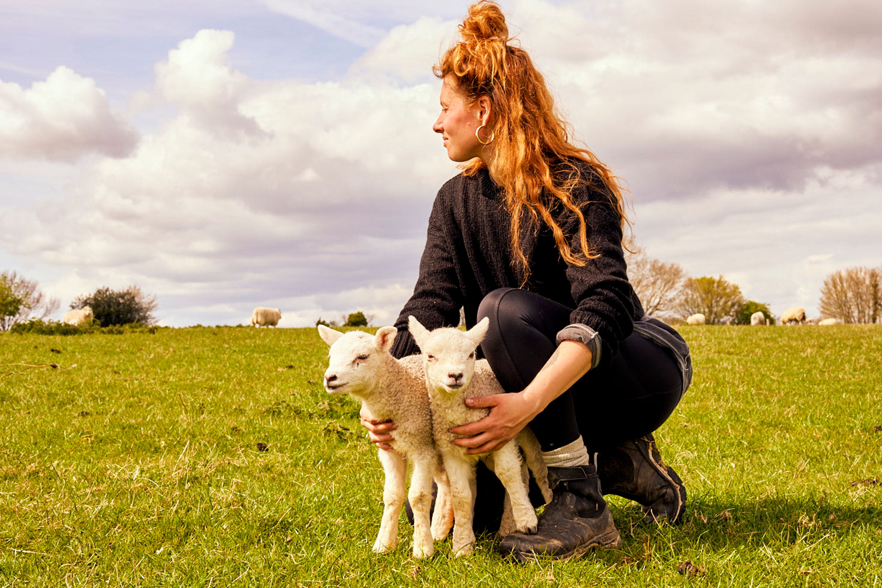 Zoe holding two lambs
