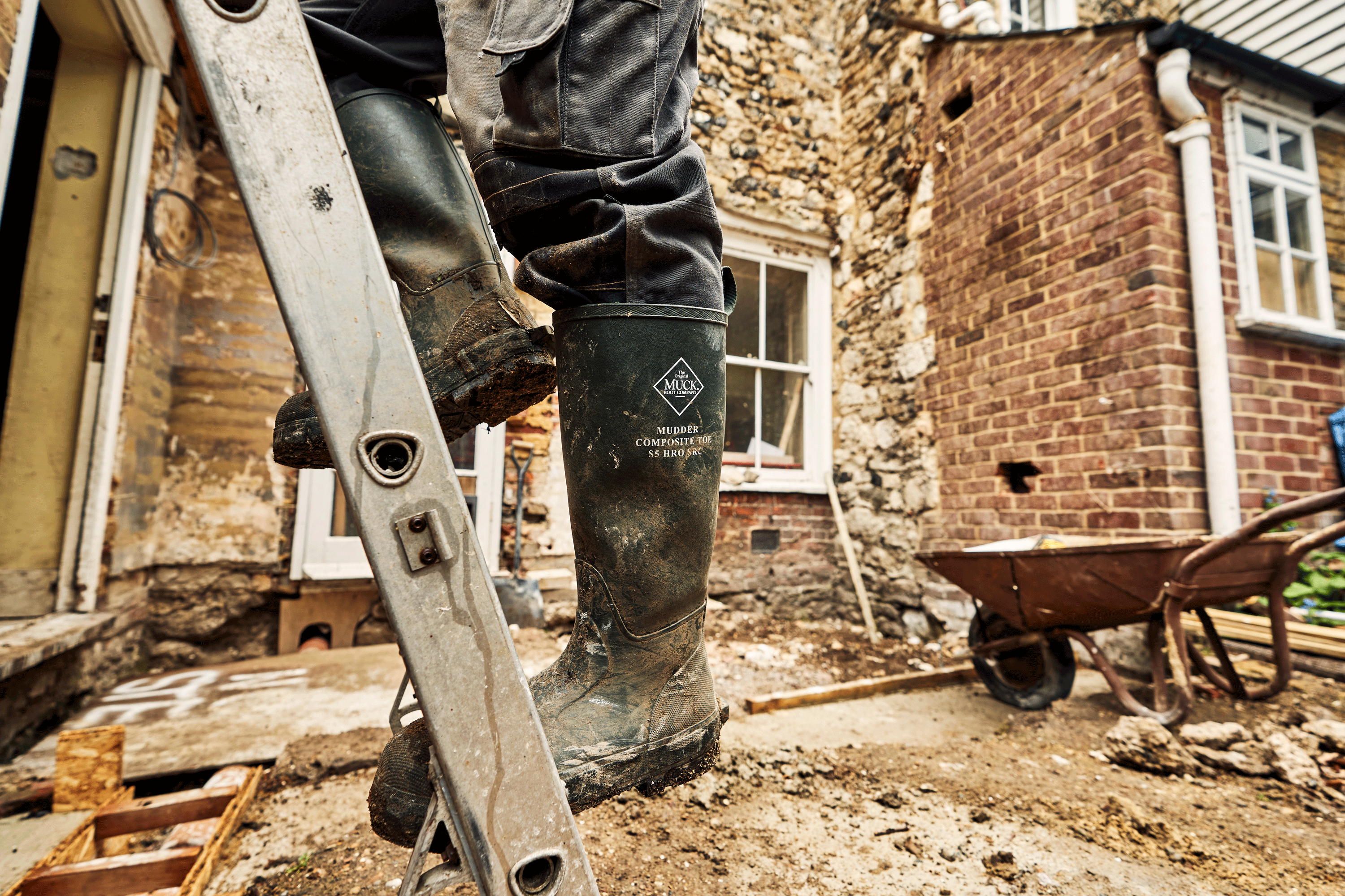 Climbing a ladder in muddy wellingtons.