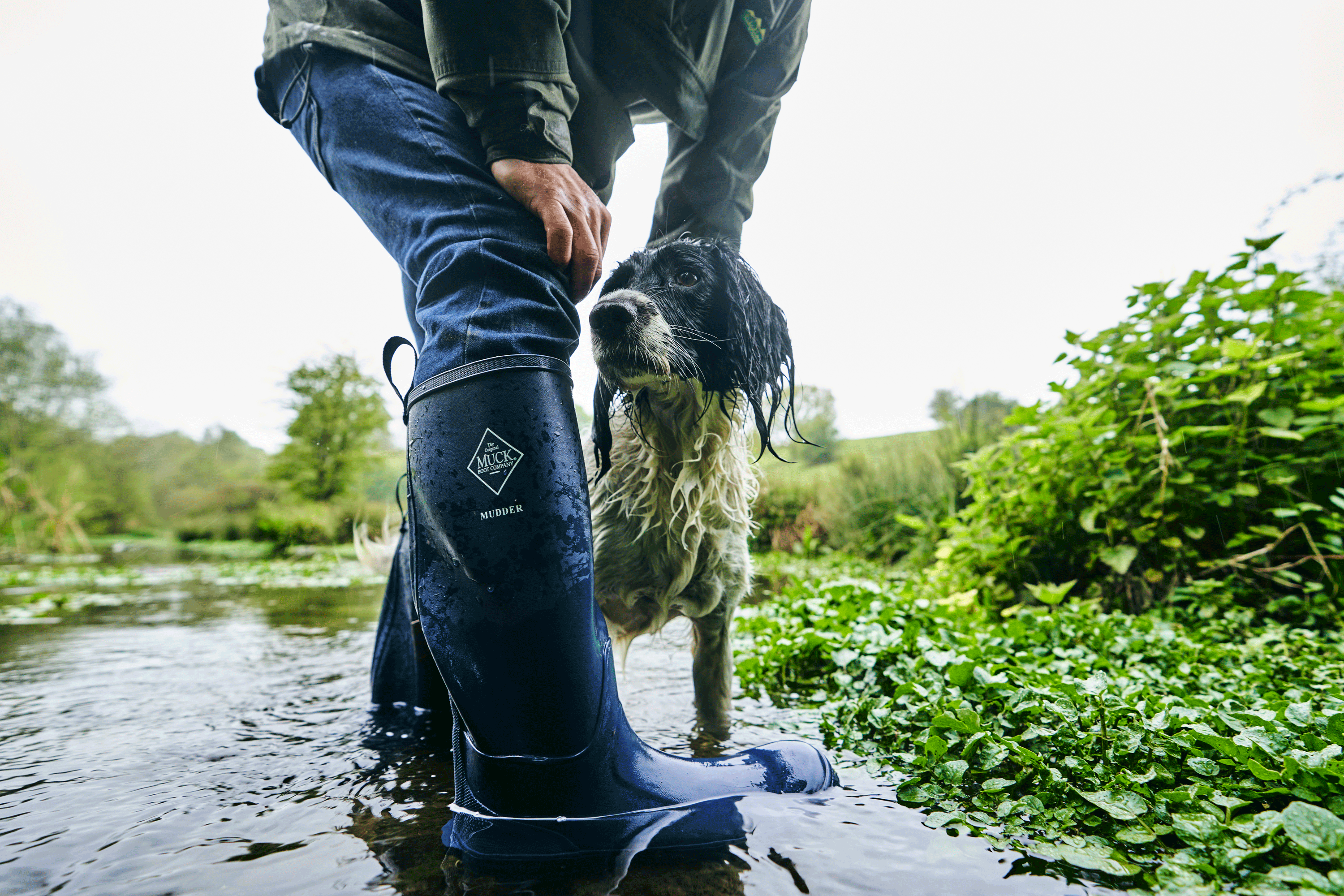 Man in a wet environment with a wet dog.