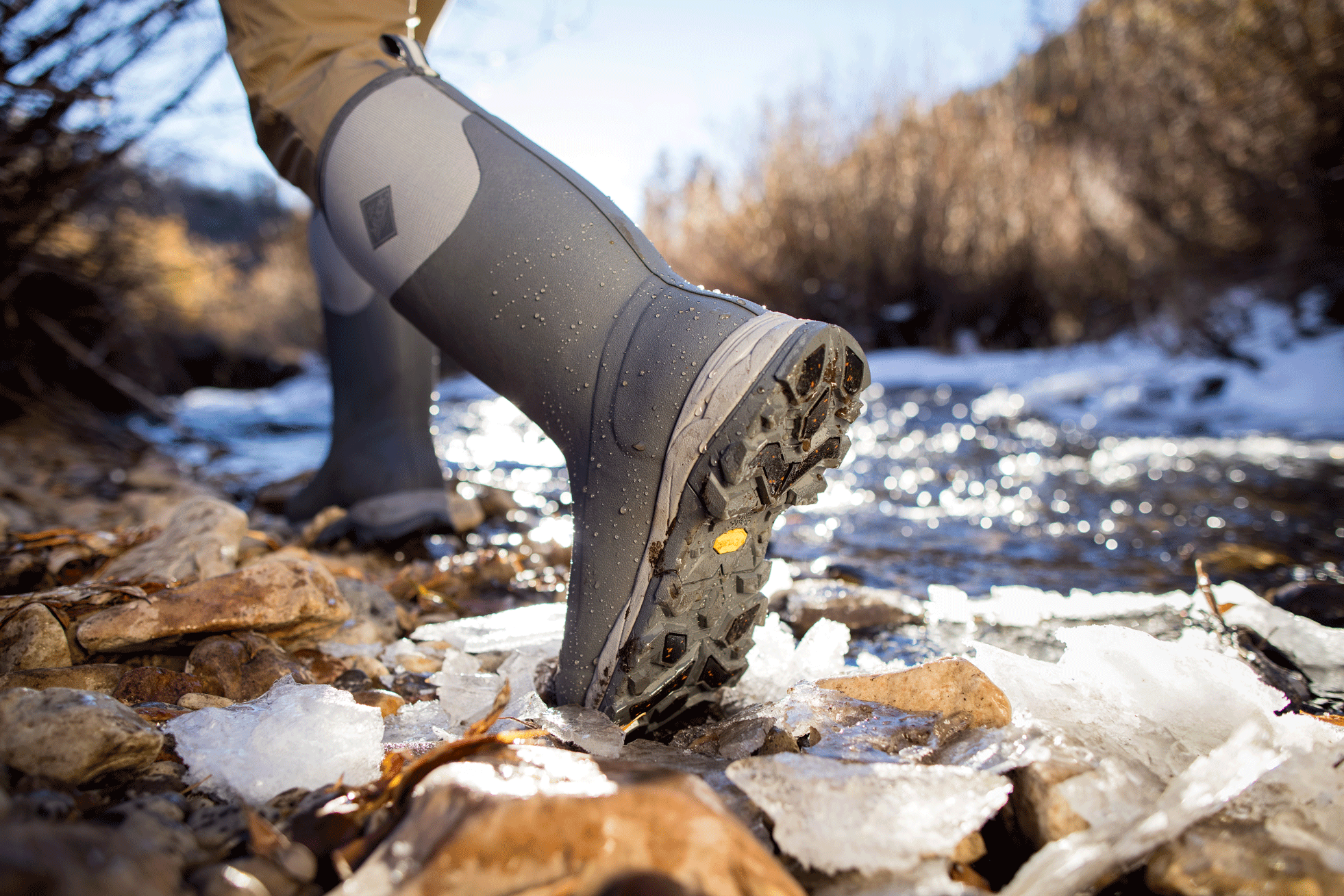 Man walking through icy river 