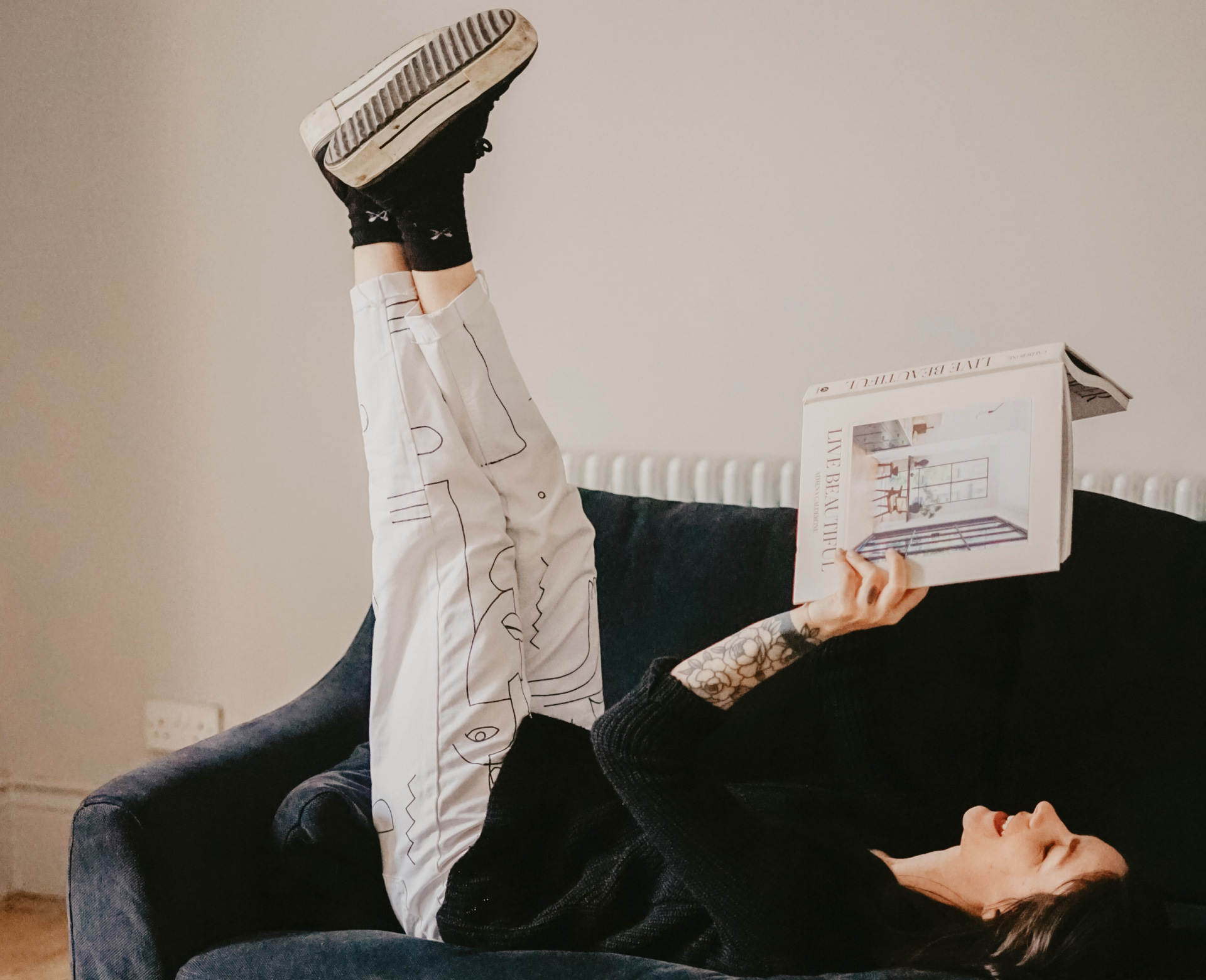 Woman Reading a Book on a couch