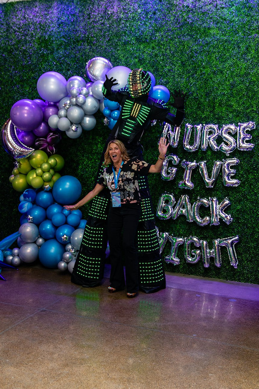 Local Detroit Nurse poses with a performer at the Nurse Inspire Nurses give back night