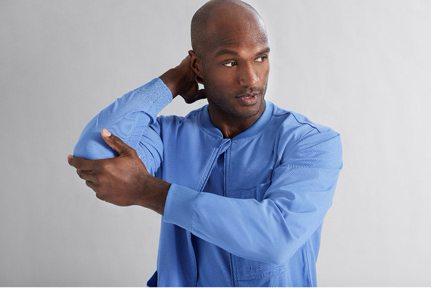 Male nurse wearing Grey's Anatomy Spandex Stretch scrubs with Anti-microbials to fight harmful pathogens. 