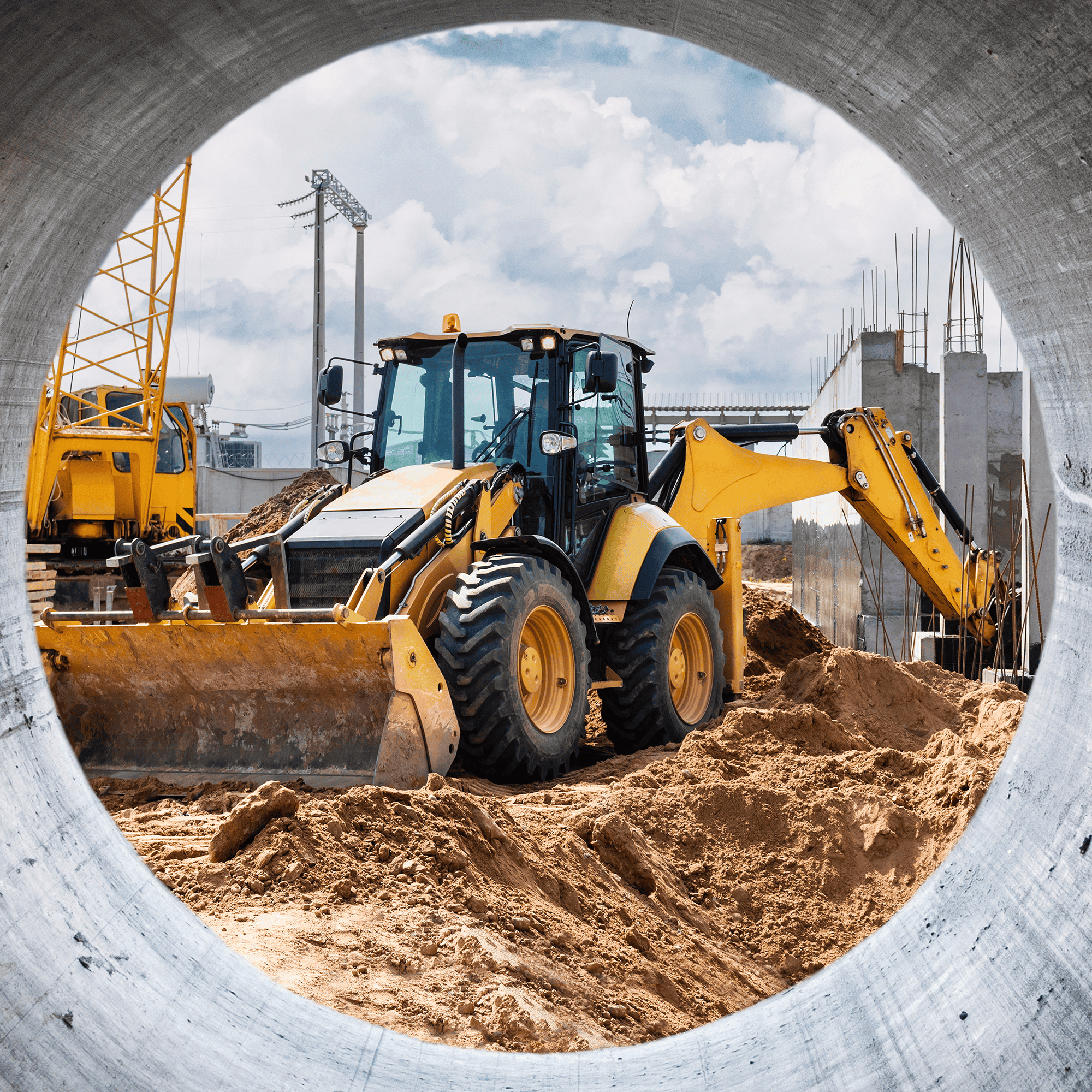 A shot of an skid steer taken from within and framed by a concrete tube