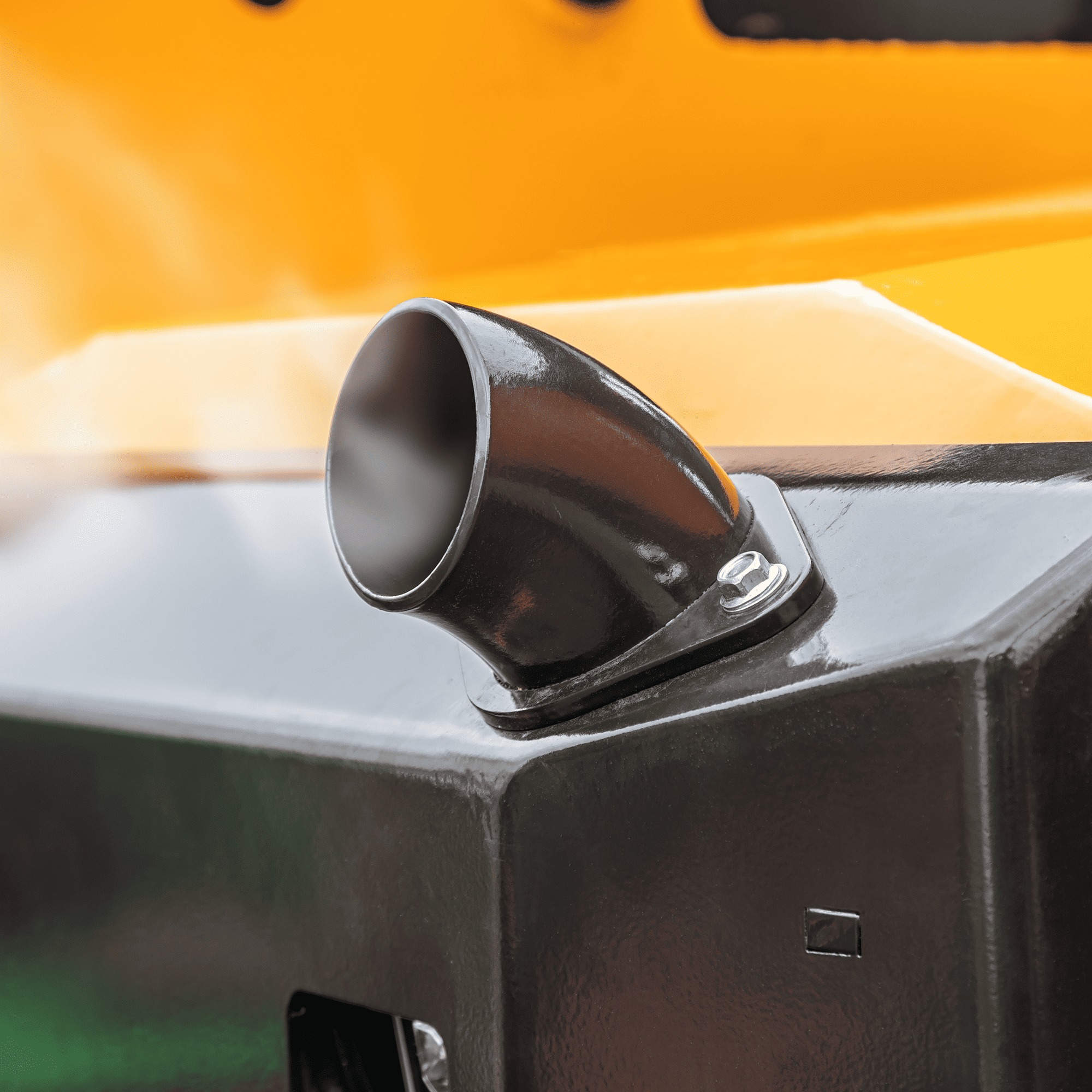 A close up of a heavy equipment exhaust pipe