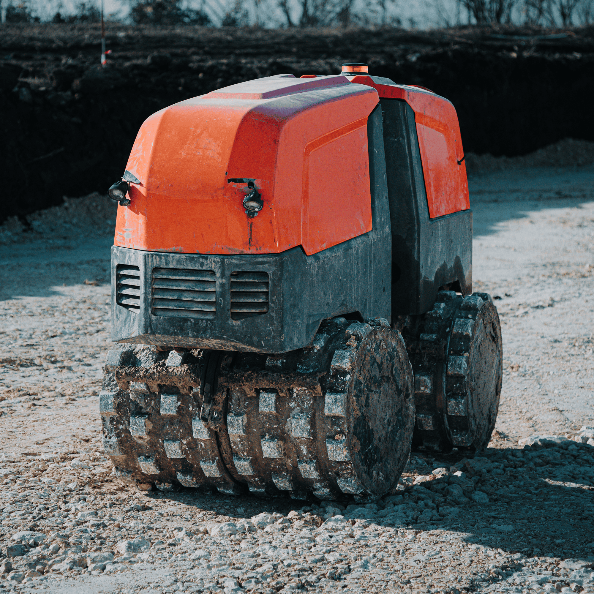 A trench roller sitting on a job site