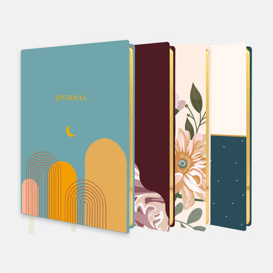 Picture of Define's Softcover Journals. The order of the journals are: Desert Moon, Marble Burgundy, Tranquil Garden, and Starrry Sky. 