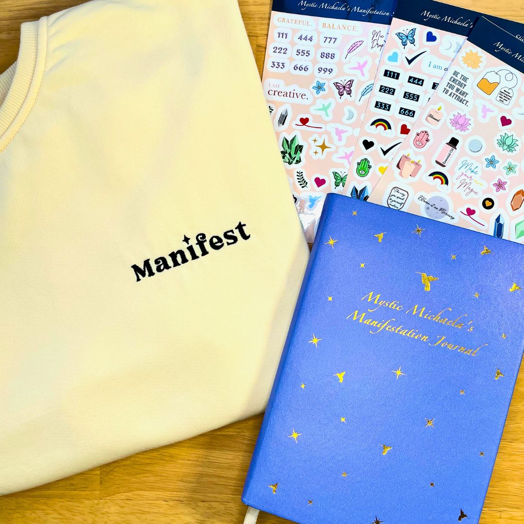 Picture of the Manifestation Journal, stickers,and sweatshirt.