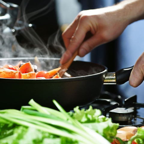 person cooking on stovetop