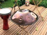 Three wodden handpan stands with a handpan on top of the front stand