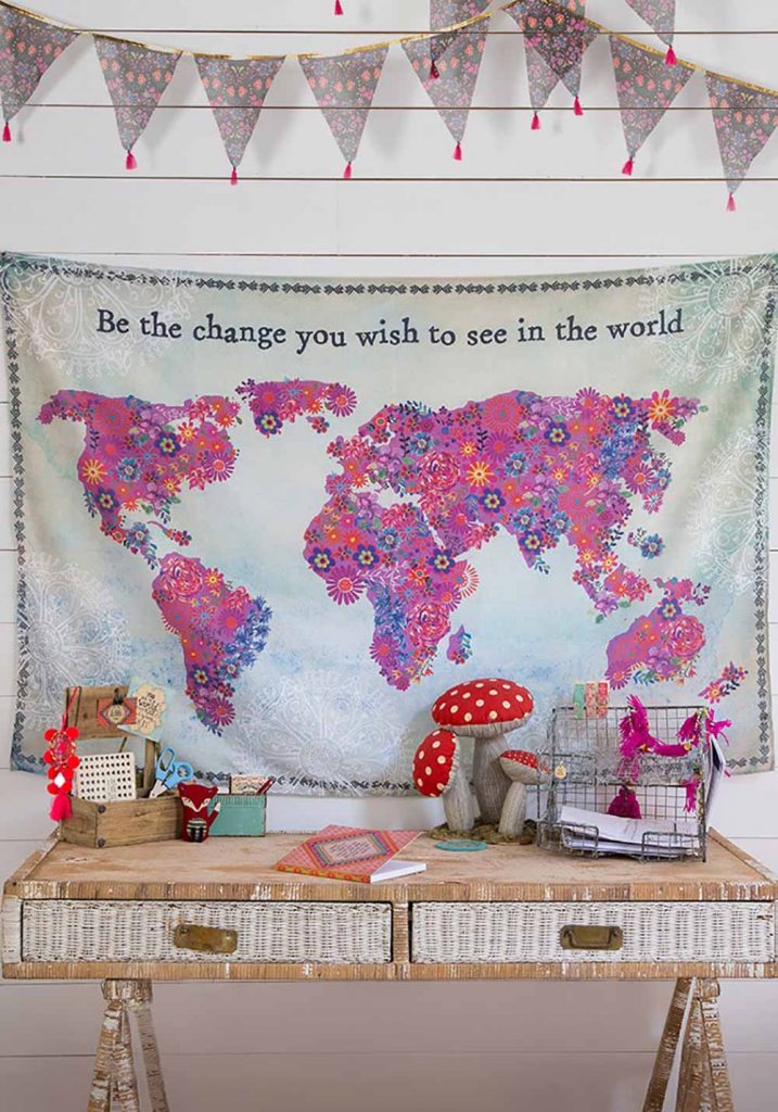 World Art Tapestry hanging over a desk decorated in bright and inspiring treasures!