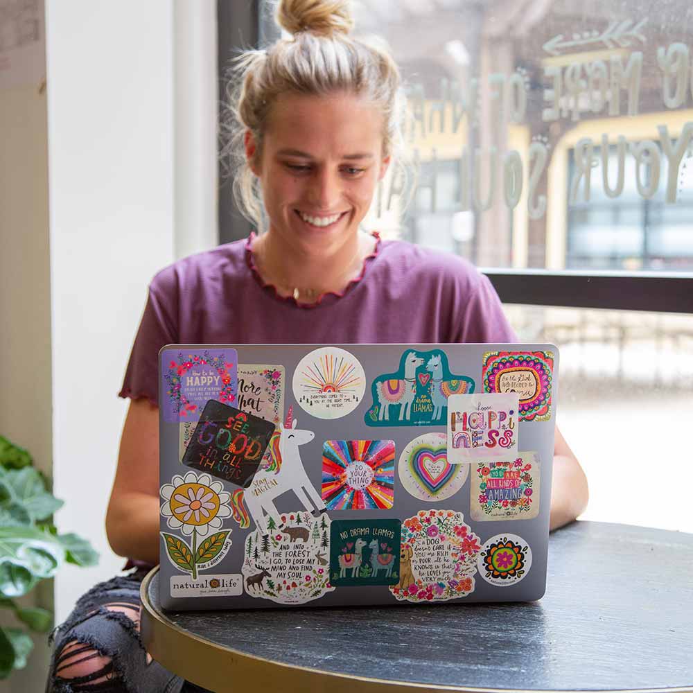 Girl on laptop with a laptop covered in fun stickers!