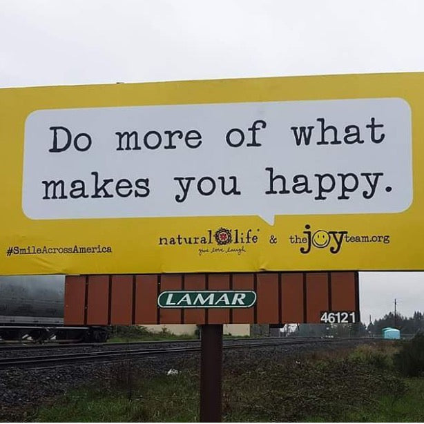 Billboard that says "Do more of what makes you happy."
