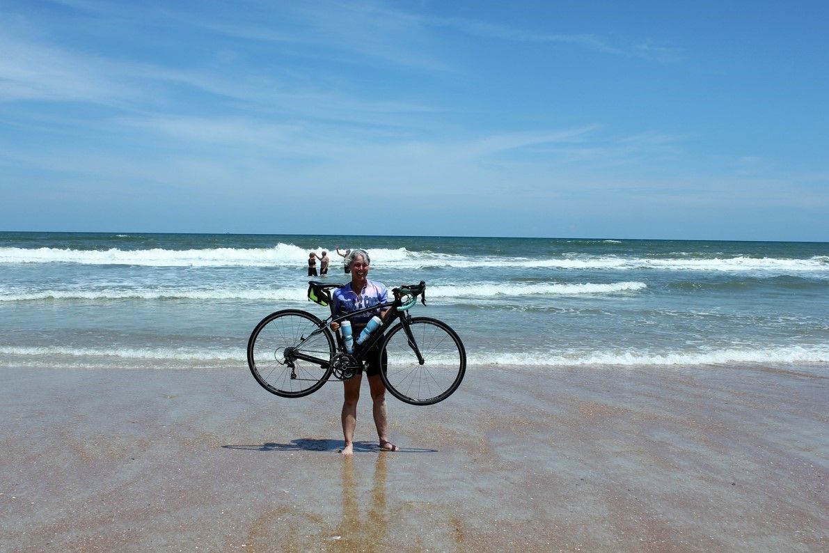 Julie and her bike at the beach