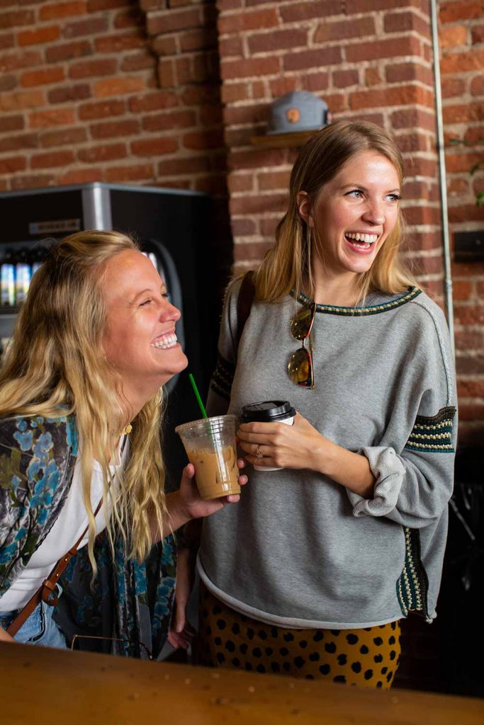 girls laughing with coffee