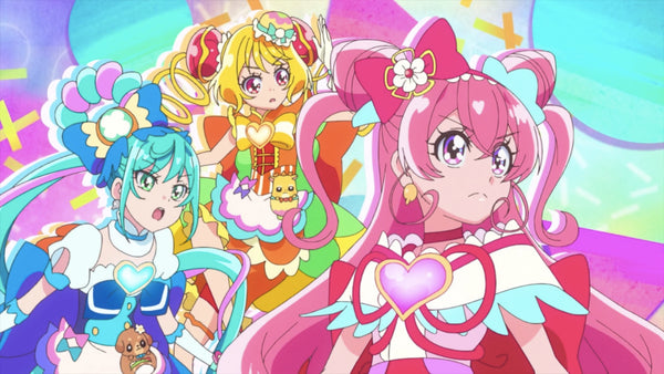 Three magical girls (Cure Spicy in blue, Cure Yumyum in yellow, and Cure Precious in pink) all standing and looking to the side