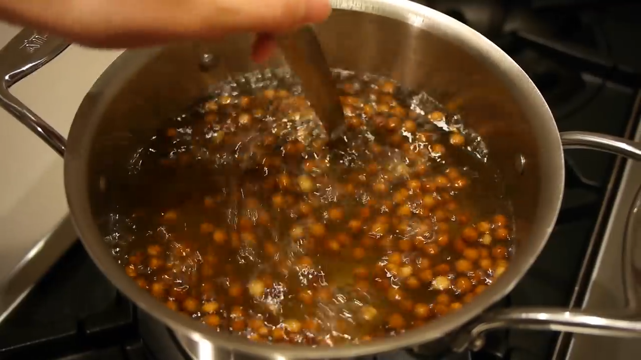spoon stirring boiling pan of boba pearls